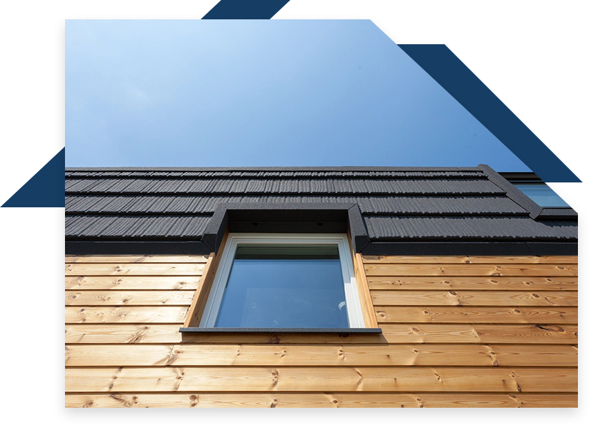 A window on the side of a building with a blue sky in background.